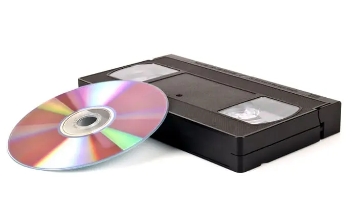 VHS cassette and CD disc on white background.